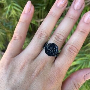 Artisan beaded black flower ring 
Can fit side 7-8 because it’s stretchy